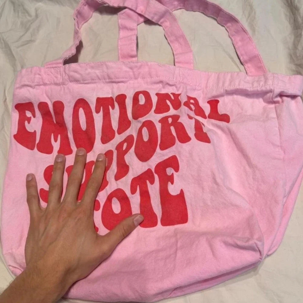 Pink tote bag with red text